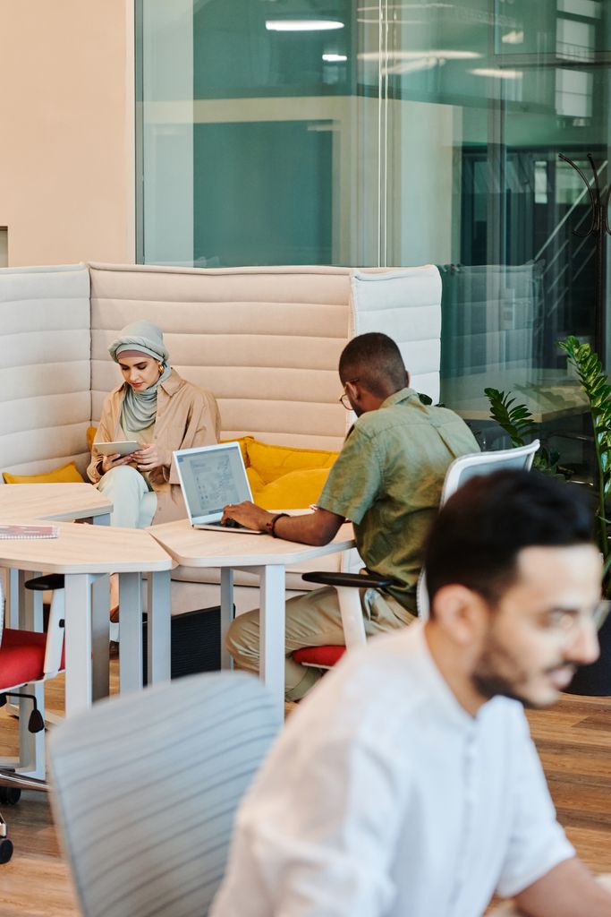 Microsoft 365 A diverse group of professionals working with technology in a modern office space, fostering collaboration and productivity.